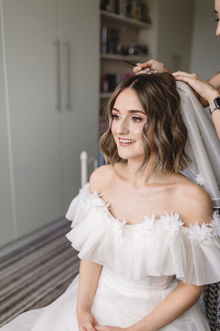 a woman getting her hair styled by another woman