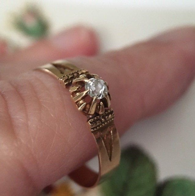 "A simply stunning engagement ring or love token! Not too much bling but full of sentiment and romance, this 14K gold Victorian ring is a charmer. The ring band is 14K gold (tested) and is approximately 1/8\" wide. The shoulders of the setting are carefully engraved. I love the unusual mounting of the diamond; the gem is cradled by multiple prongs which create a star-like effect. The small but sparkly diamond is 3 mm in diameter or approximately .11 carats. The ring is a US size 6.75. This antiq 14k Gold Engraved Ring With Rose Cut Diamonds, Antique Gold Engraved Promise Ring, Antique Yellow Gold Jewelry With Single Diamond, Victorian Gold Engraved Promise Ring, Victorian 14k Gold Diamond Cut Rings, Heirloom Gold Engraved Ring With Rose Cut Diamonds, Heirloom Gold Ring For Promise, Gold Rose Cut Diamond Ring For Promise, Gold Promise Ring With Rose Cut Diamonds