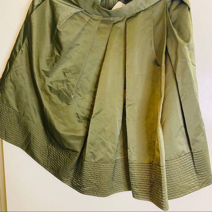 Olive Green/Military Green Skirt With Trim Detail And Side Pockets. It’ll Give You Lots Of Personality Spring Pleated Khaki Bottoms, Khaki Midi Skirt For Spring, Relaxed Khaki Skirt For Spring, Relaxed Fit Khaki Skirt For Spring, Khaki Flowy Skirt For Spring, Spring Flowy Khaki Skirt, Khaki Lined Midi Skirt, Spring Workwear Skort With Full Skirt, Green Knee-length Mini Skirt For Spring