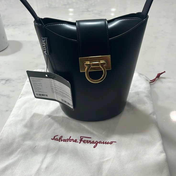 Salvatore Ferragamo Bag, Shoulder Bag, Black, Nwt Designer Bucket Bag With Gold-tone Hardware For Business, Designer Office Bucket Bag, Designer Satchel Bucket Bag For Office, Elegant Calf Leather Bucket Bag For Evening, Designer Calf Leather Bucket Bag For Evening, Designer Evening Bucket Bag, Designer Rectangular Bucket Bag With Branded Hardware, Designer Bucket Bag With Detachable Handle For Business, Luxury Evening Shoulder Bag In Bucket Shape