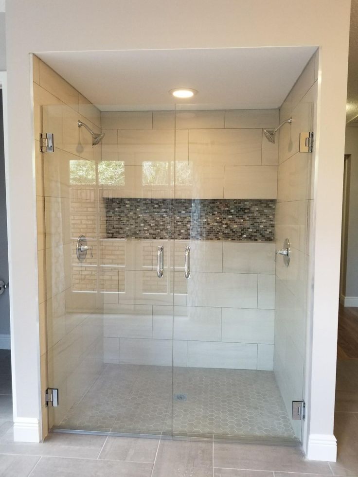 a walk in shower sitting inside of a bathroom