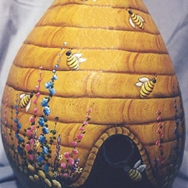 a beehive shaped vase with bees on it