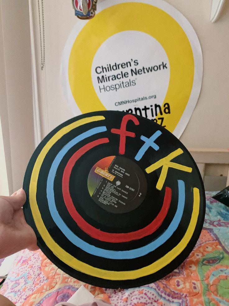 a person holding up a record with children's mirae network on it