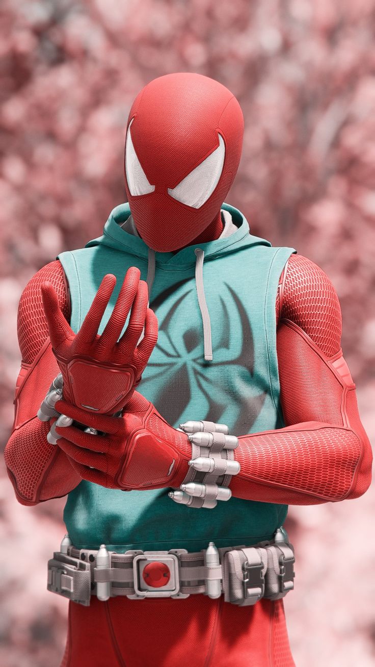 a spider - man is holding his hands out in front of the camera, while wearing red gloves