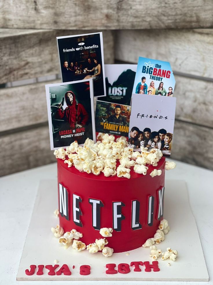 a cake that has some movies on it and popcorn in the middle with movie posters