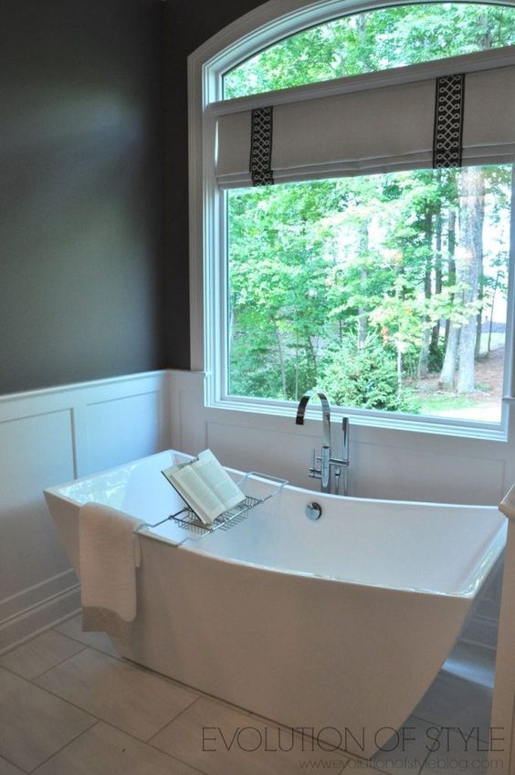 a white bath tub sitting next to a window