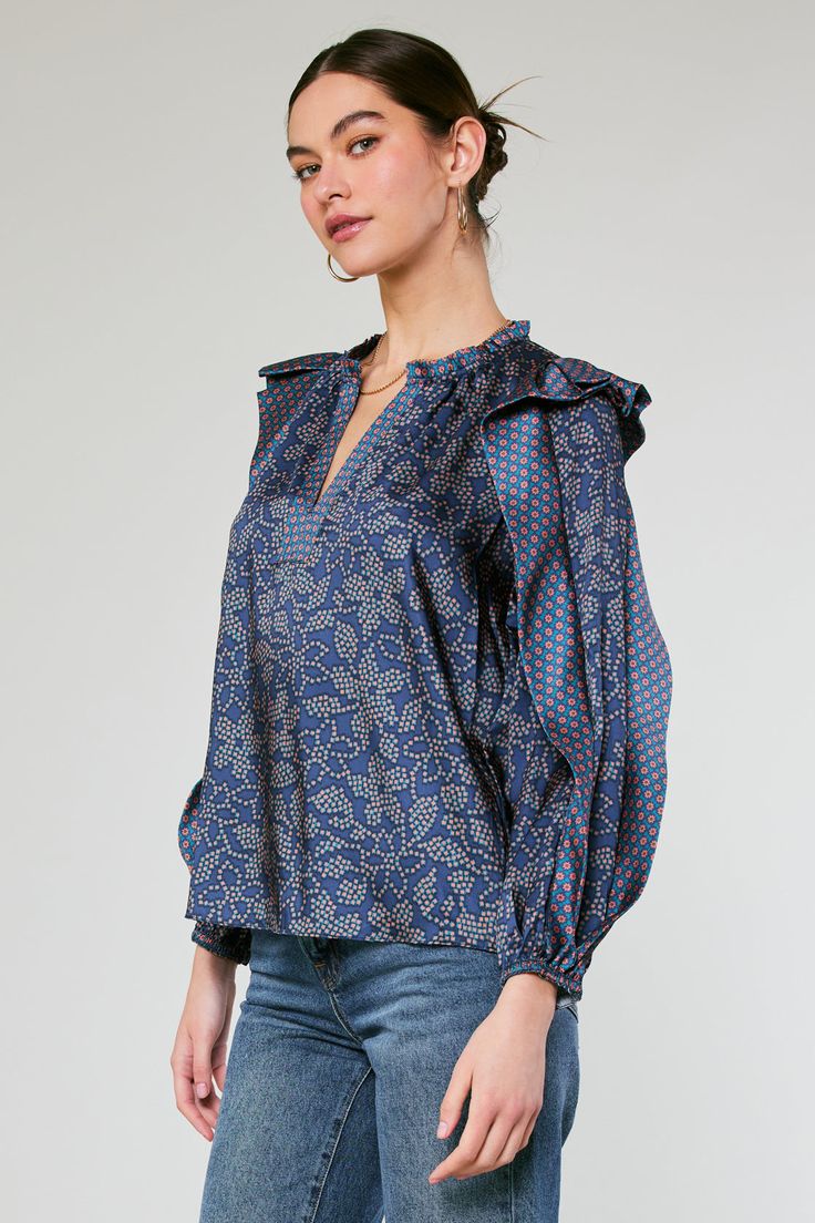 Done in a playful floral motif, this blouse has long sleeves traced with a dramatic ruffle in a contrasting print. It's cut for a loose, easy fit that's defined by a split neckline. •Split neckline •Long sleeves with ruffle detail •Elasticized cuffs •Relaxed fit •Original 'Floral Constellation' print, designed by Current Air Item number 2330175 100% Polyester Chic Ruffled Split Neck Blouse, Chic Split Neck Blouse With Ruffles, Fall Printed Split Neck Blouse, Patterned Long Sleeve Top With Ruffles, Blue Split Neck Blouse For Fall, Fall Floral Print Blouse With Ruffled Collar, Blue Ruffled Collar Blouse For Fall, Blue Floral Print Split Neck Blouse, Blue Floral Print Blouse With Split Neck