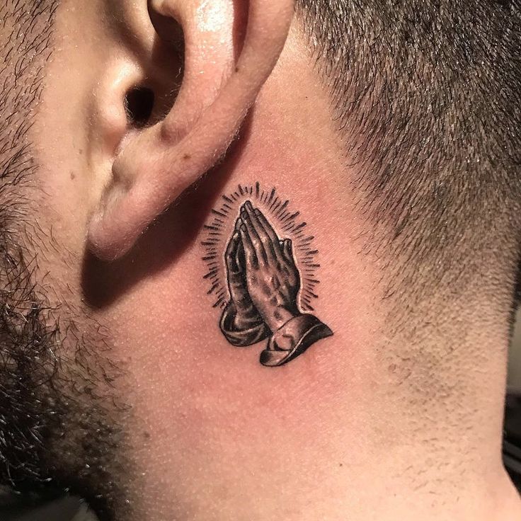 a man with a tattoo on his neck and behind the ear that has a praying hand