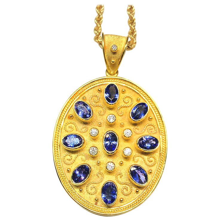 S.Georgios unique designer pendant is all handmade in 18 Karat Yellow Gold and custom-made. It's microscopically decorated - with granulation work all the way around in Gold 22 Karat beads and wires shaped like the last letter of the Greek Alphabet - Omega, which symbolizes eternal life. The background of the pendant has a gorgeous unique velvet look and features 7 Brilliant cut Diamonds total weight of 0.53 Carat and 9 Oval Tanzanite's total weight of 4.41 Carat. The pendant can be custom made Diamond Necklace Pendant, Faberge Jewelry, Vintage Pendant Necklace, Tanzanite Jewelry, Antique Pendant, Vintage Necklaces, Gold Necklace Set, Ancient Jewelry, Antique Necklace