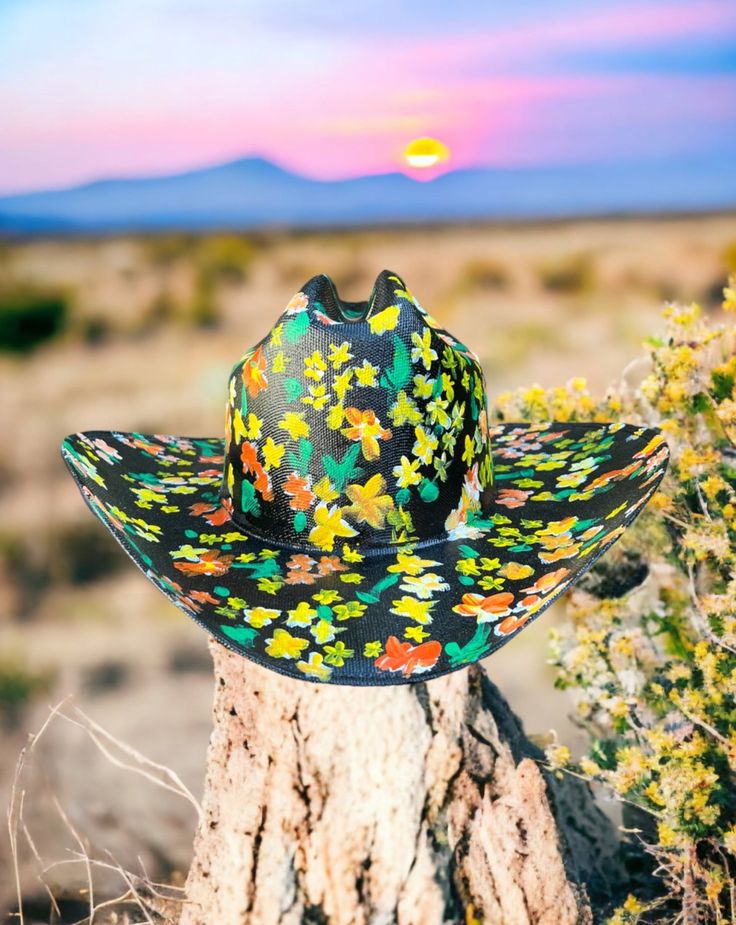 Eve is inspired from Caroline Constas's stunning floral dress. Hard canvas cowboy hat, with a hand-painted flowers adorning the entire hat. Proudly American Made. Our hats are manufactured in Mexico and details added by hand in Los Angeles, CA using the highest quality materials. SIZING S/M 19in-22.75in | 48cm-57.5cm L/XL 19.5in-23.25in | 49.5cm-59cm **Please allow up to 2 weeks for production and shipping.** If you need your order rushed, please send us an email. We can almost always accommodate rushed orders at no additional cost.* CUSTOM OPTIONS AVAILABLE. Spring Sun Hat With Curved Brim For Western-themed Events, Handmade Ranch Hats For Spring, Artisan Fitted Summer Hat Bands, Fitted Hat For Western-themed Spring Events, Multicolor Curved Brim Sun Hat For Rodeo, Multicolor Sun Hat With Curved Brim For Country Events, Multicolor Curved Brim Sun Hat For Country Events, Whimsical Summer Hats For Country Events, Multicolor Country Style Straw Hat For Country Events