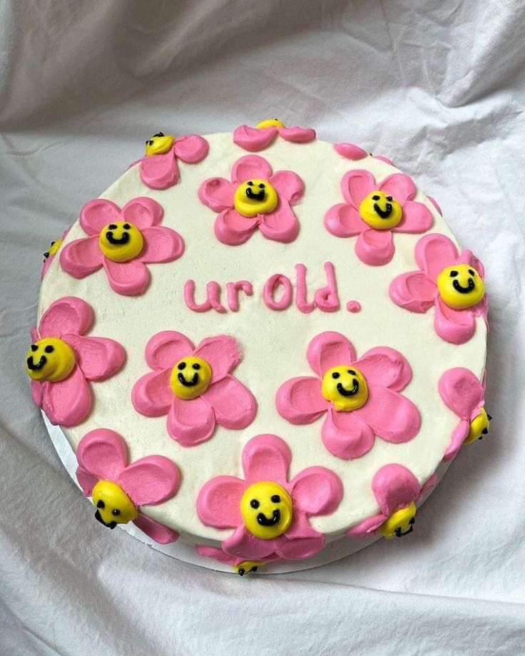 a decorated cake with pink and yellow flowers on it that says u - o d