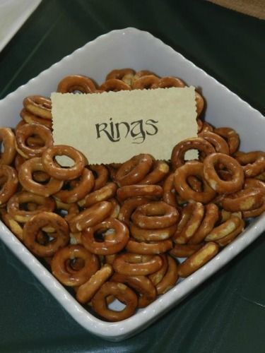 a white bowl filled with pretzels sitting on top of a table