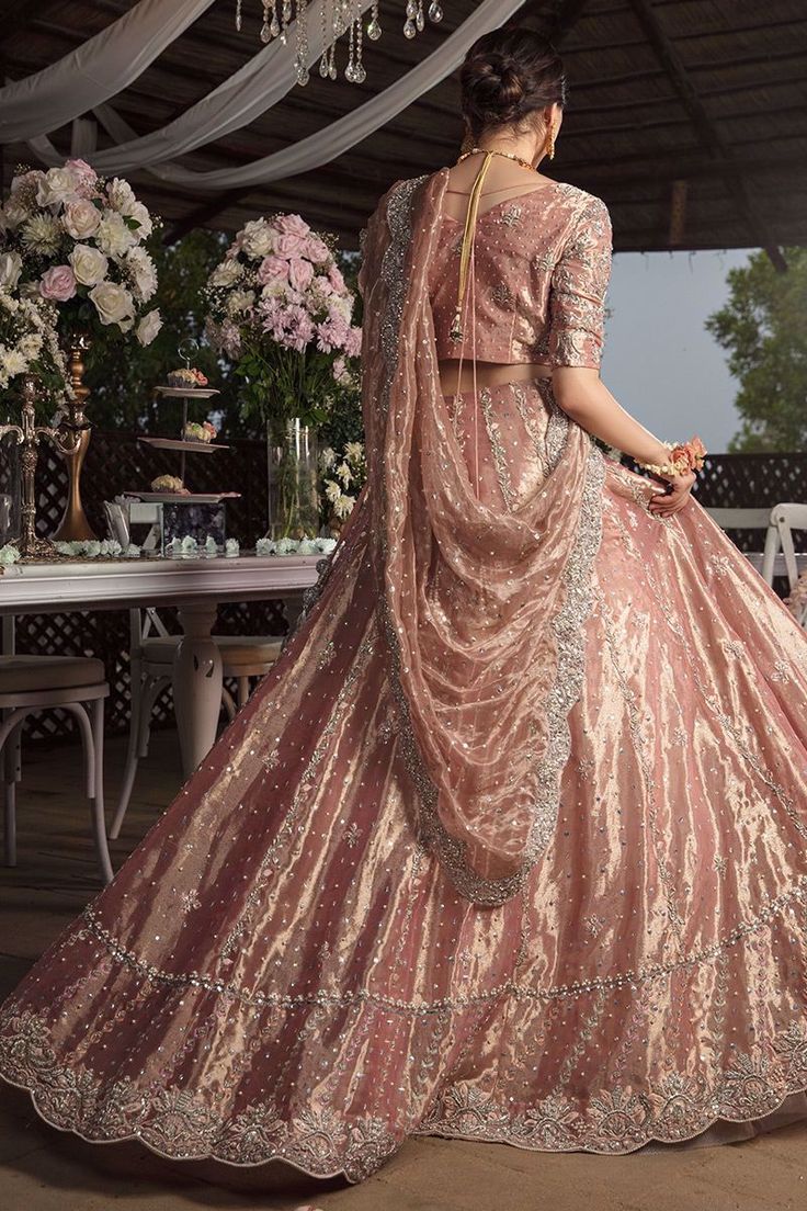 Pakistani Valima Lehnga Choli with Embroidery dabka and sequins. This lehnga is unique in style and have classy look and perfect choice for traditional bride. Choli: Short Choli for bridal dress in Malmaison Rose color is embellished with embroidery, antique dabka, nakshi, stones, kamdani work. Neckline is décor with embroidery and without sleeves. Fabric used for choli is shimmer raw silk. Lehnga: Stylish lehnga in Malmaison Rose color is embellished with sequins, dabka, crystals, stones, cutda Shimmer Lehenga, Desi Wedding Dresses, Asian Bridal Dresses, 3 Piece Outfit, Bridal Dresses Pakistan, Rose Fabric, Pakistani Wedding Outfits, Asian Bridal, Pakistani Bridal Dresses