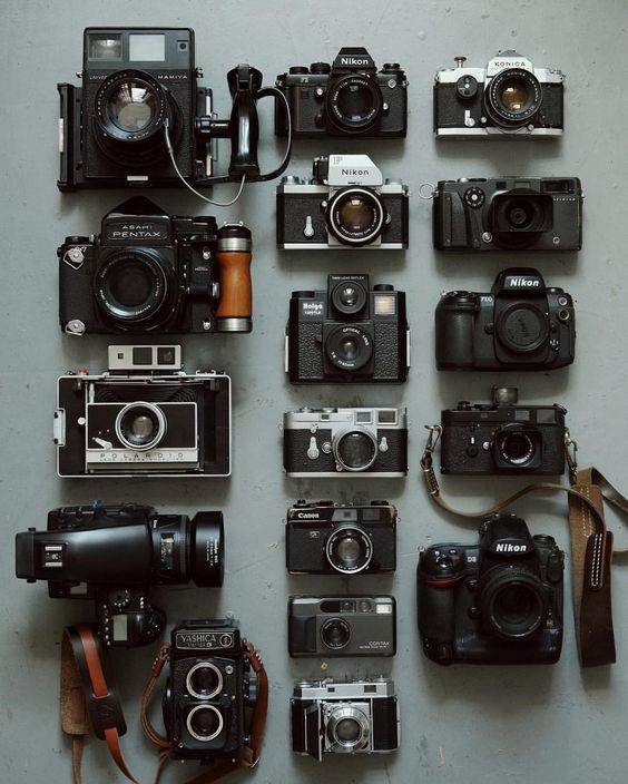 many different types of cameras sitting on top of a table