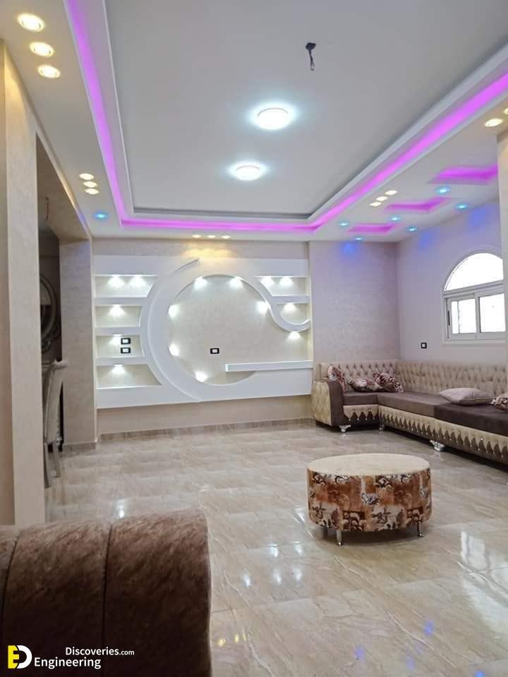 a living room filled with lots of furniture next to a wall mounted flat screen tv