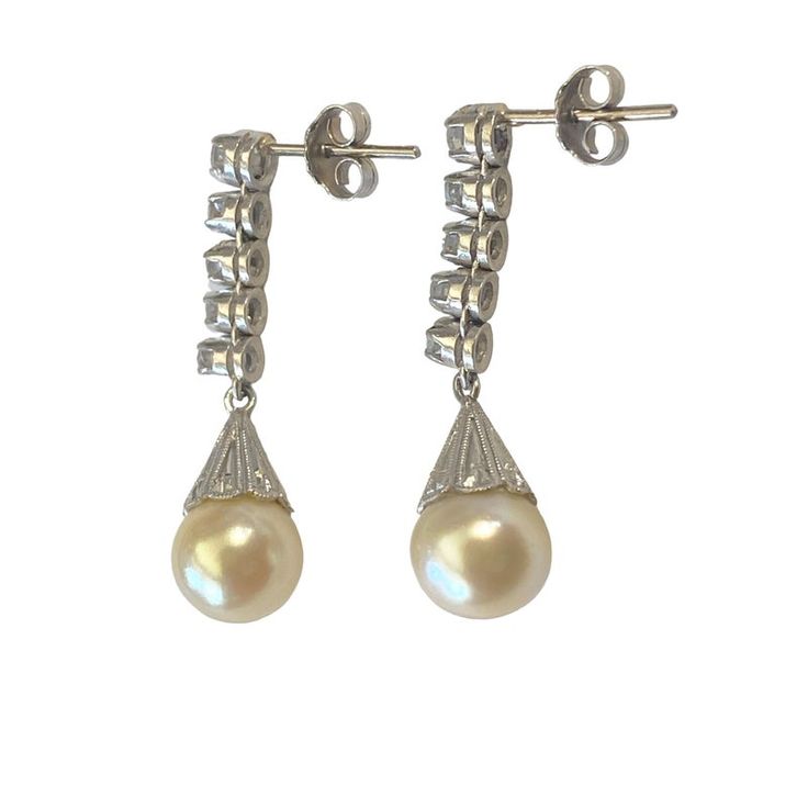 Superb and elegant Ladies Cultured Pearl & Diamond Stud  Dangle Earrings  14K White  Gold each set with 8mm medium grade capped yellowy creme colored cultured pearl, accented with five diamonds. 1 full cut @ 2.4mm 05 points and 4 single cuts @ 1.8mm 02 1/2 points L colors VS clarities ,Gold weight = 4.5 dwt / 6.99grams  1.25" approx long by 0.25" w by 0.50" D amazing in person  thanks Classic Diamond Pearl Earrings With Elegant Design, Classic Pearl Earrings With Diamond, Classic Pearl Earrings With Diamond Accents For Evening, Classic Pearl Drop Diamond Earrings, Formal High Luster Pearl Drop Earrings, Classic Dangle Earrings With High Luster, Classic Diamond Drop Pearl Earrings, Classic Diamond Earrings With Pearl Drop, High Luster Sterling Silver Pearl Earrings For Formal Occasions