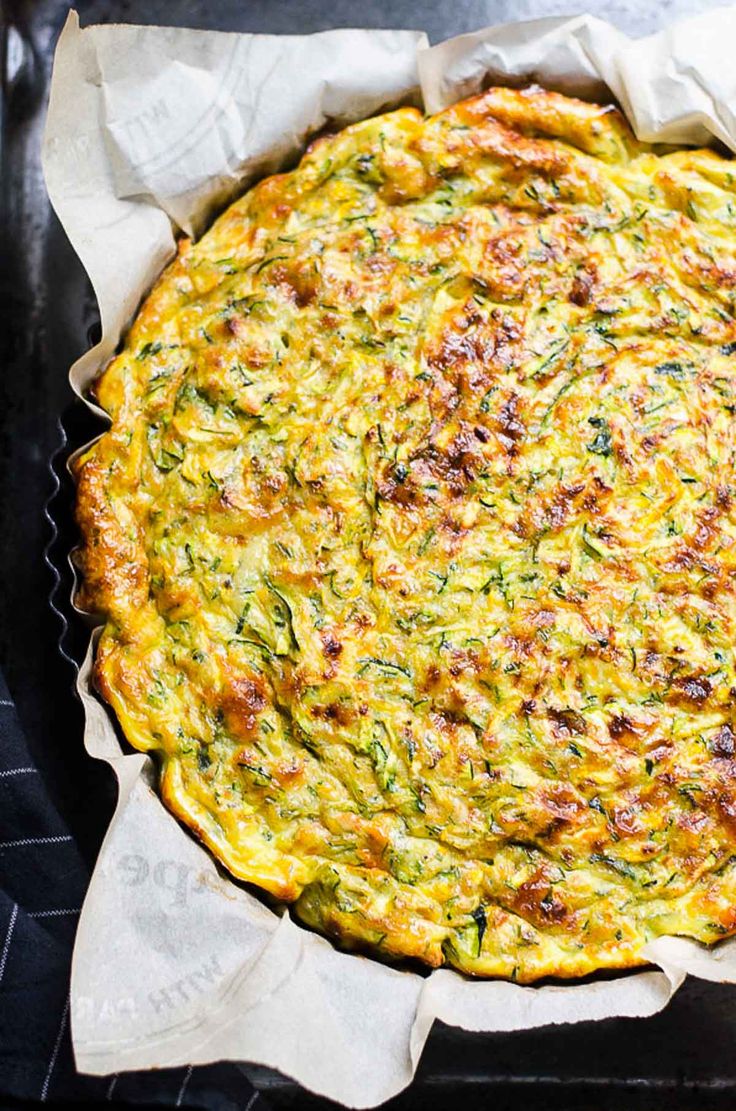 an omelet sitting on top of a pan covered in wax paper