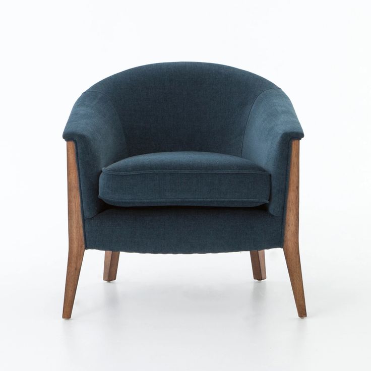 an upholstered blue chair with wooden legs and arm rests on a white background