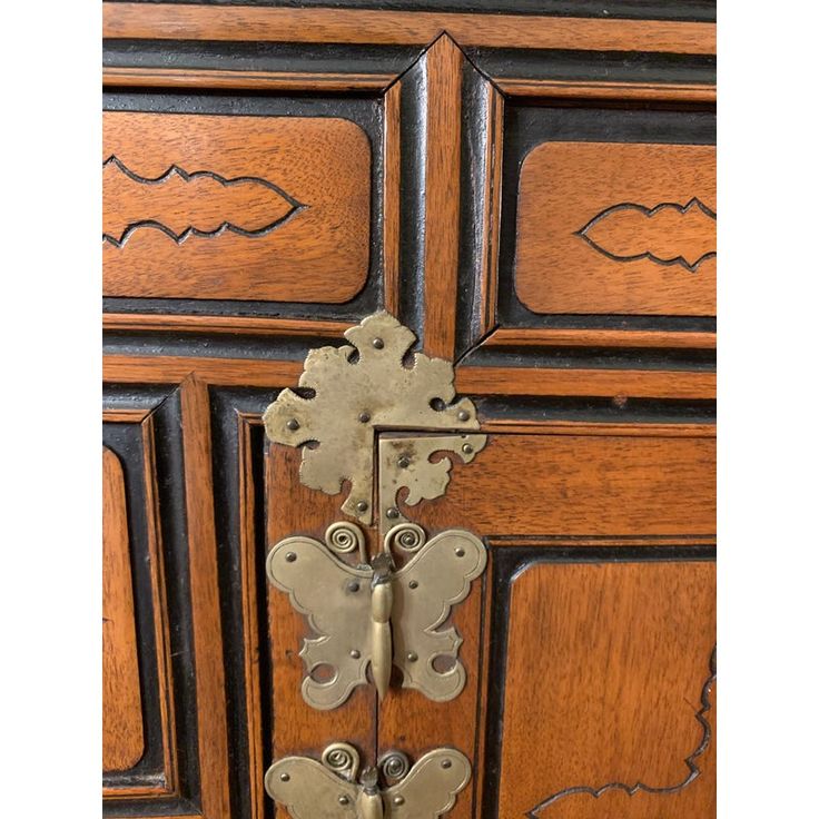 an ornate wooden door with metal handles