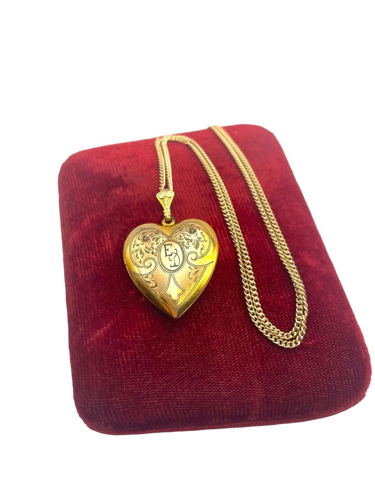 Description: Beautiful vintage 12K gold filled locket.  This locket features etched flowers, leaves and swirling designs on the front with the center an oval and monogrammed initials (I believe they are "ED" but the second letter is open to interpretation).   The fanned bale is decorative and has some nice embellishments that complement the locket front.   The back of the locket is plain with no design. The locket is on the larger side, and is hallmarked WH in one of the wells. This stands for t Retro Era, Heart Locket Necklace, Vintage Lockets, Flowers Leaves, Heart Locket, Jewelry Companies, Locket Necklace, Spring Rings, Jewelry Gift