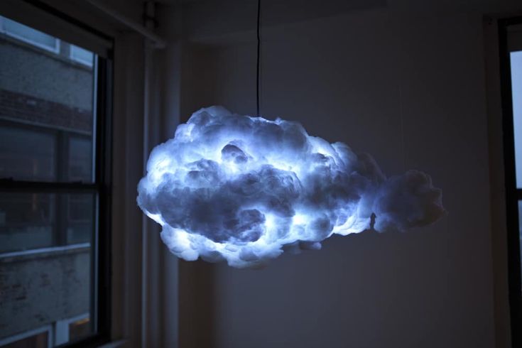 a cloud shaped light hanging from the ceiling