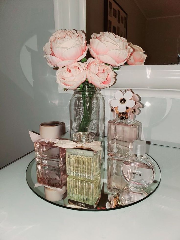 a glass table topped with bottles and flowers