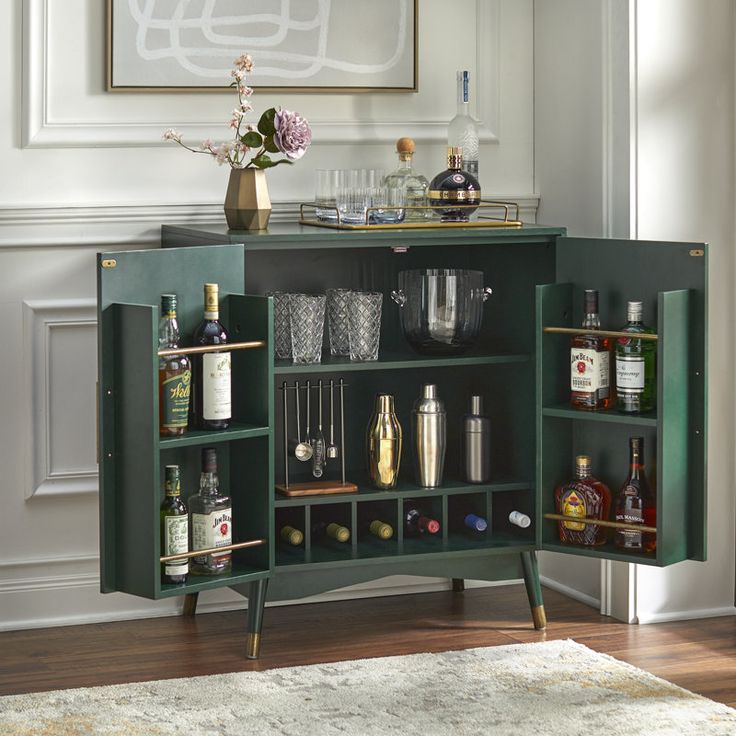 a green cabinet with liquor bottles and glasses on it in front of a white rug