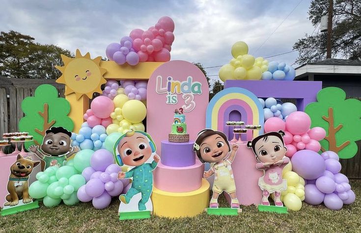 there are many balloons and decorations on the lawn for children's birthdays to play in