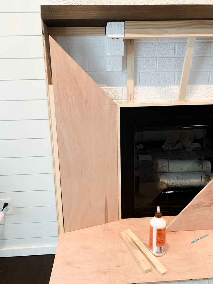 a fireplace being built with plywood and glue