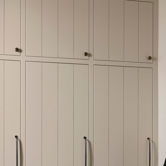 an image of a kitchen setting with white cupboards and black countertop spacer