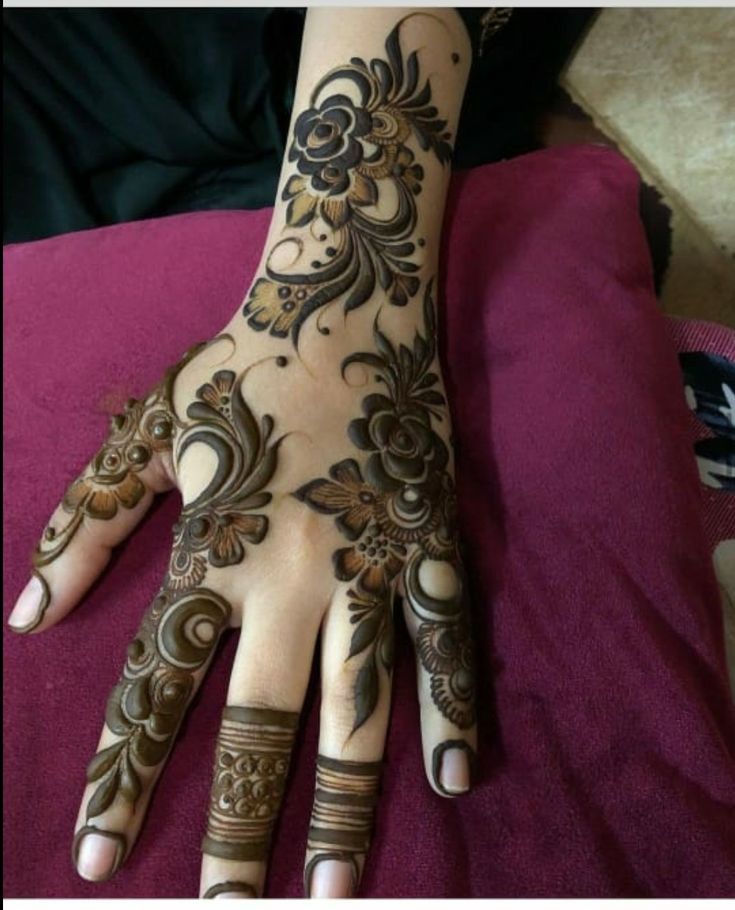 a woman's hand with hennap on it, showing the intricate design