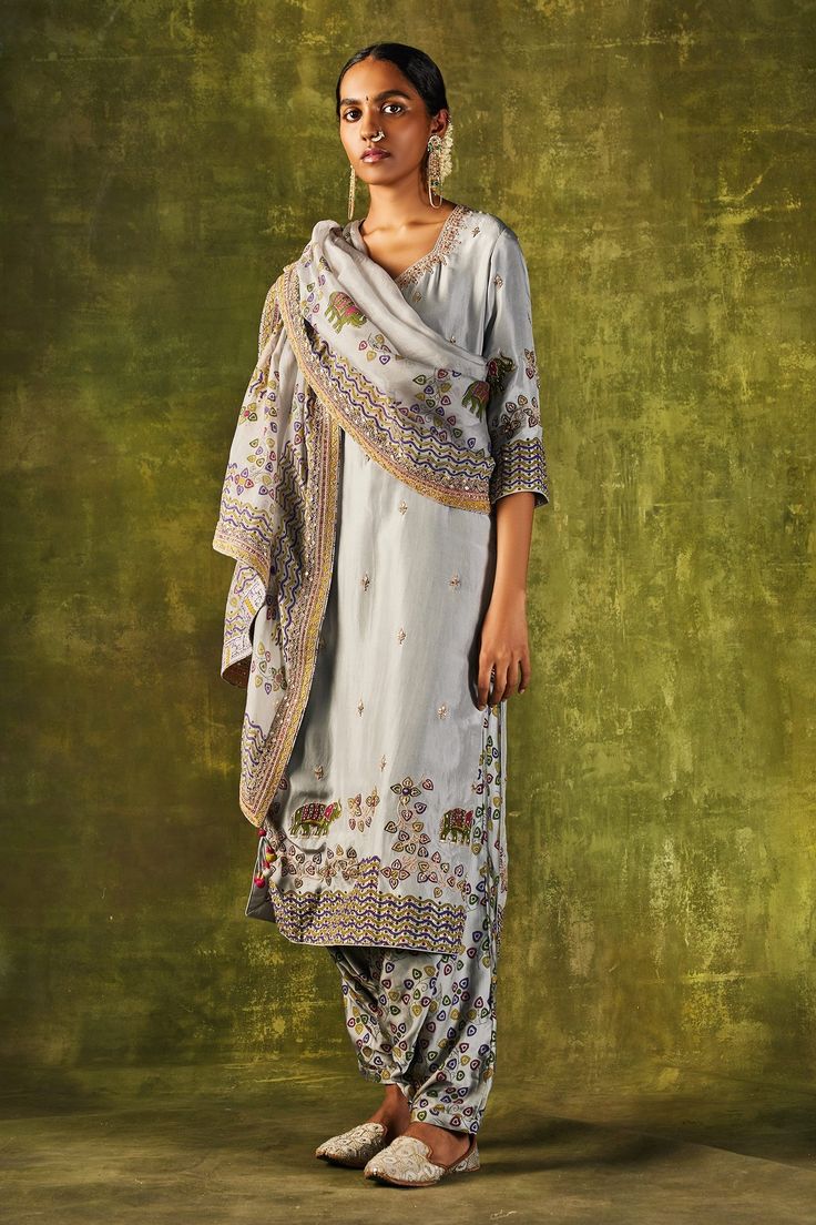 Grey hand block printed kurta embroidered with dori and zardozi work. Paired with printed organza dupatta and cowl pant.
Component: 3
Pattern: Printed,Embroidered
Type Of Work: Dori and Marodi Work
Neckline: V Neck
Sleeve Type: Long Sleeves
Fabric: Silk, Satin Silk
Color: Grey
Other Details: 
Printed dupatta
Floral and animal print
Occasion: Mehendi, Mehendi - Aza Fashions Marodi Work, Punit Balana, Printed Organza, Zardozi Work, Kurta Pant Set, Printed Dupatta, Gray Silk, Organza Dupatta, Indian Fashion Designers