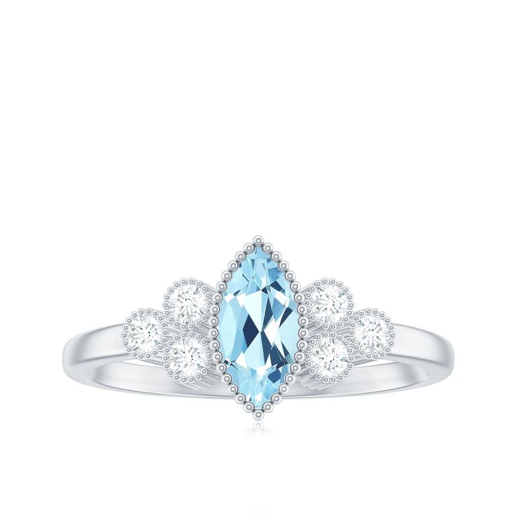 a blue topazte and diamond ring with three diamonds on the band, set in white gold