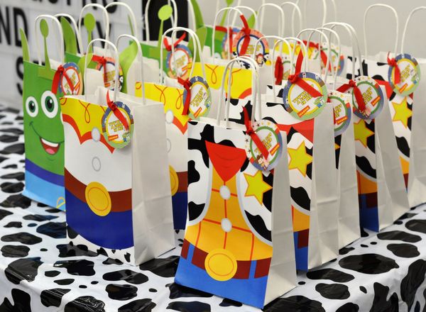 small bags are lined up on a table with polka dots and cartoon characters painted on them