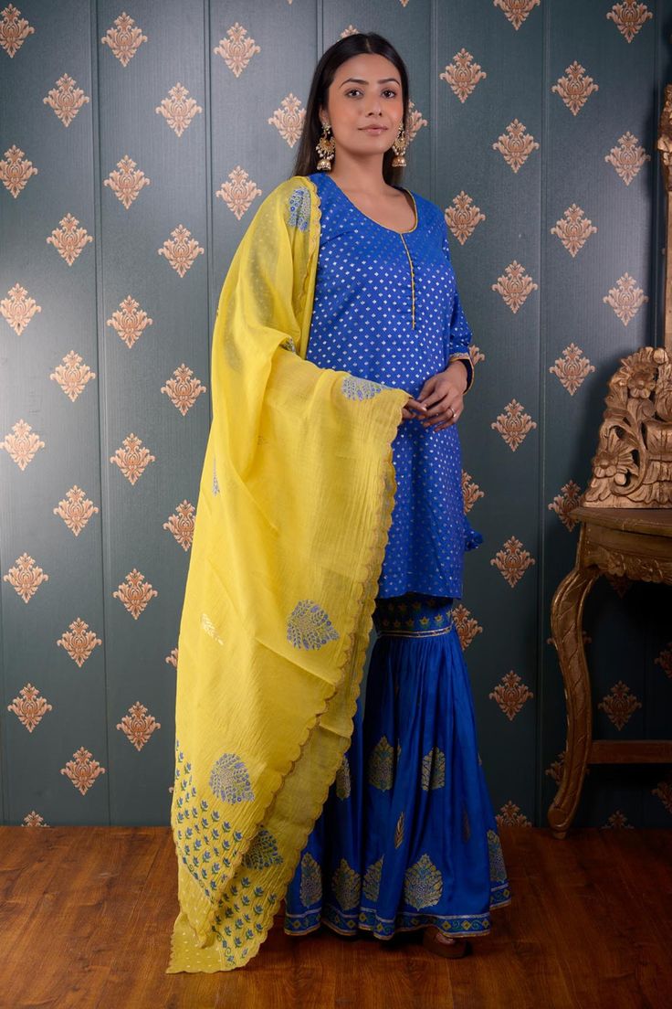 Royal blue kurta with foil print motifs and lace trim on the sleeve hems. Comes with sharara and yellow chanderi dupatta.
Component: 3
Pattern: Print
Type Of Work: Foil Print
Neckline: Round
Sleeve Type: Three Quarter
Fabric: Kurta: Banarasi Chanderi, Sharara: Cotton Satin and Dupatta: Chanderi
Color: Blue
Other Details: 
Printed dupatta with scalloped border
Side slits
Potli button front detailing
Occasion: Wedding - Aza Fashions Print Motifs, Kurta Sharara Set, Kurta Sharara, Blue Kurta, Printed Dupatta, Types Of Work, Blue Foil, Sharara Set, Foil Print