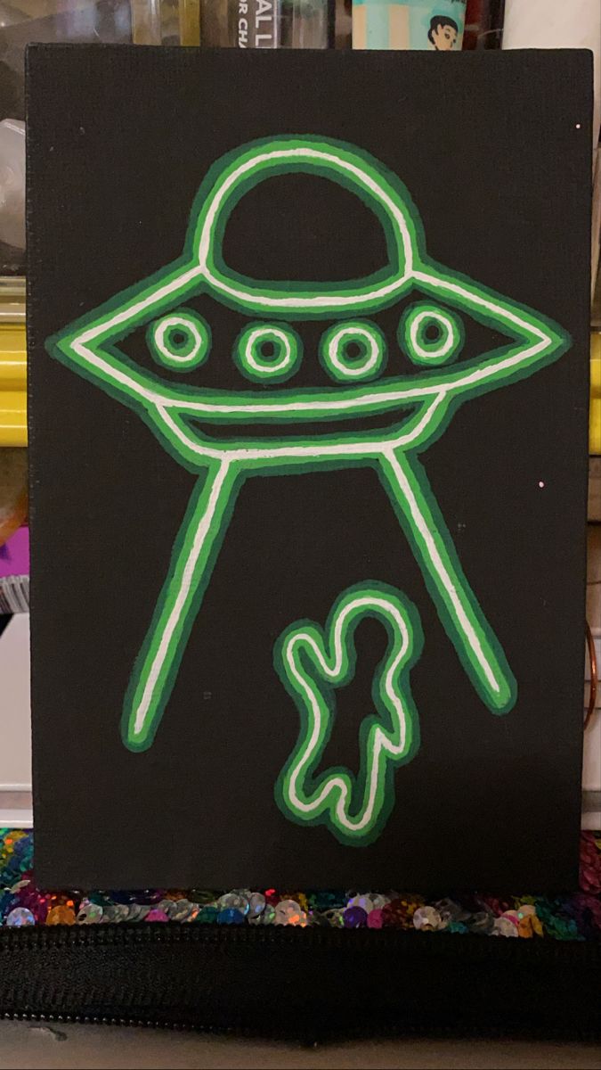 a neon sign with an alien on it