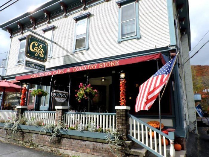 an american flag is hanging on the outside of a store