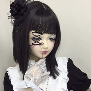 a doll with black hair and white dress