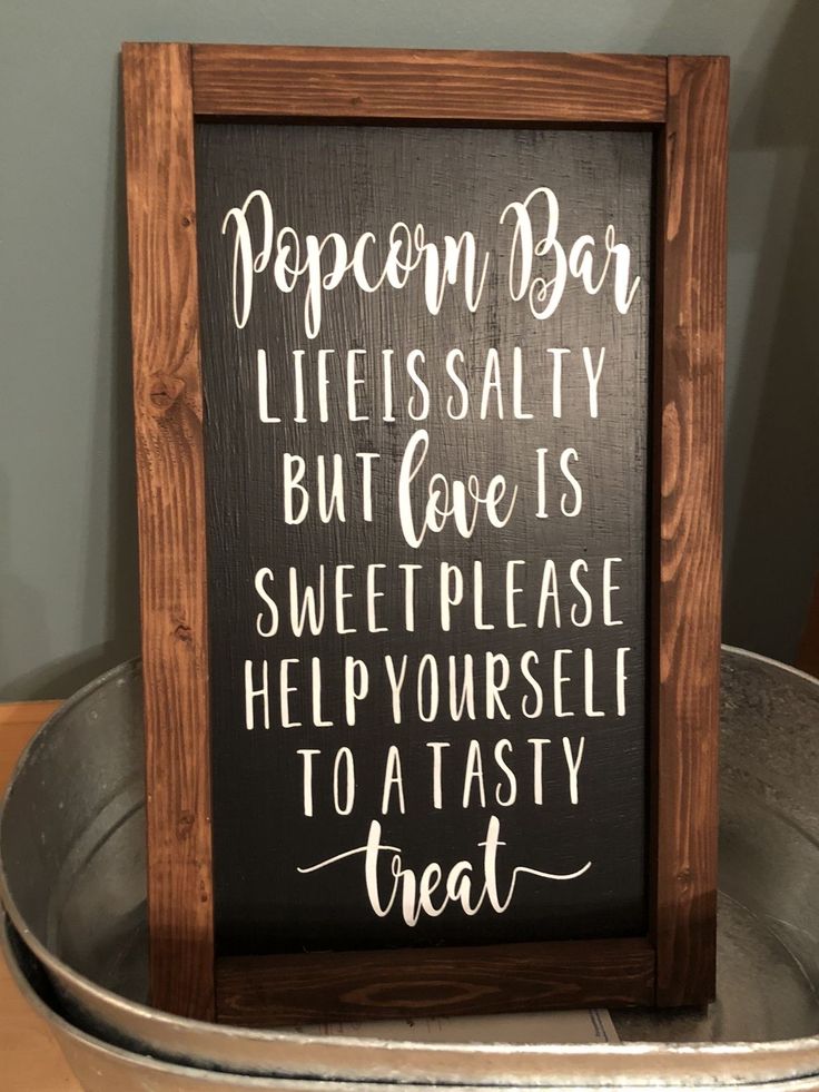 a sign that says popcorn bar lies salty but love is sweet please help yourself to tasty treat