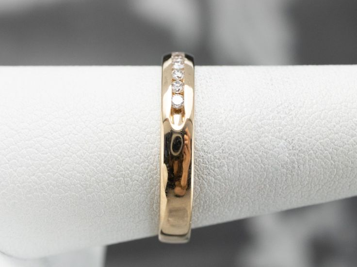 a close up of a gold ring with diamonds