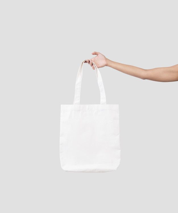 a person holding a white shopping bag in their left hand, on a gray background