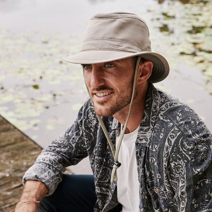 The Boat Yard Outdoor Fedora is made from recycled plastic bottles and features an inner pocket with a floating device so if it goes over board, you can still retrieve your hat! Has a cotton chin cord, mesh ventilation and anti glare under the brim. #Hat  #MensFashion  #OutdoorHats  #HikingHat Fisherman Hat Outfit, Boat Yard, Tilley Hat, Adventure Hat, Boat Hat, Hiking Hat, Different Hats, Boater Hat, Outdoor Hats