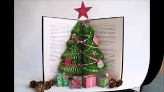 an open book with a christmas tree on it