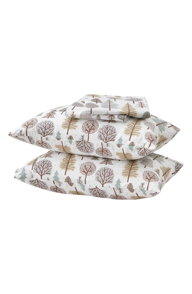 three pillows with trees printed on them