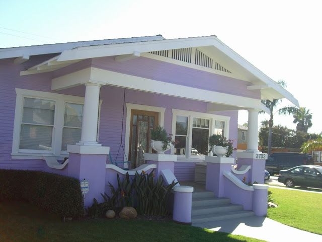 a purple house with white trim and windows