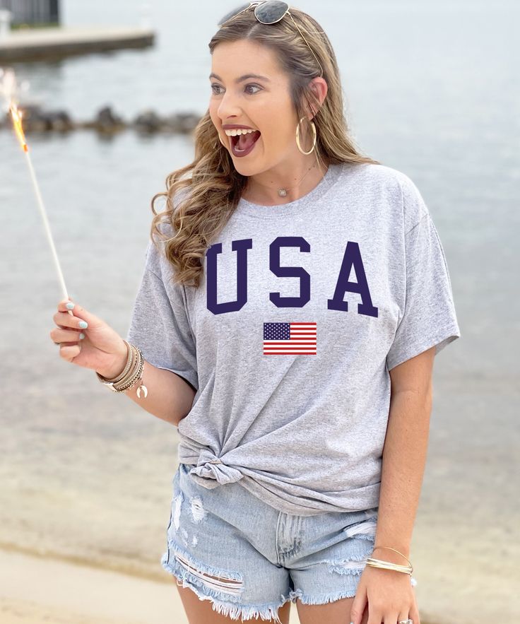 Red, white, and blue! Summertime is a time of great American pride this USA Flag Shirt is perfect for summer bbq's, Memorial Day, Labor Day, and of course the 4th of July! Get yours now and be ready to celebrate all summer long! *6.0 oz. 90/10 cotton/polyester *Double-needle stitched neckline, bottom hem and sleeves Graphic Tee For Game Day And Summer, Summer Game Day Crew Neck Top, Summer Game Day Graphic Tee, Summer Game Day Tops With Relaxed Fit, Relaxed Fit Tops For Game Day In Summer, Summer Relaxed Fit Tops For Game Day, American Style Flag Print Top For 4th Of July, Summer Flag Print T-shirt With Relaxed Fit, American Style Shirt With American Flag For Summer