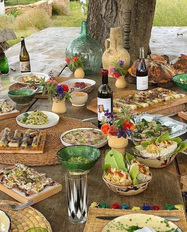 a table full of food and wine bottles