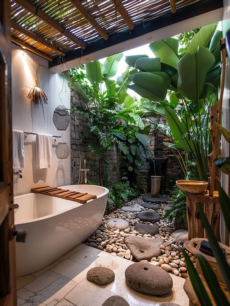 a bathroom with a tub, rocks and plants in it