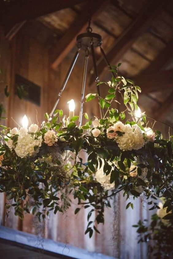 a chandelier with flowers hanging from it