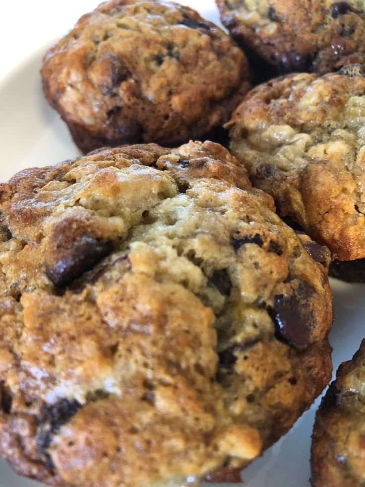 several chocolate chip muffins on a white plate